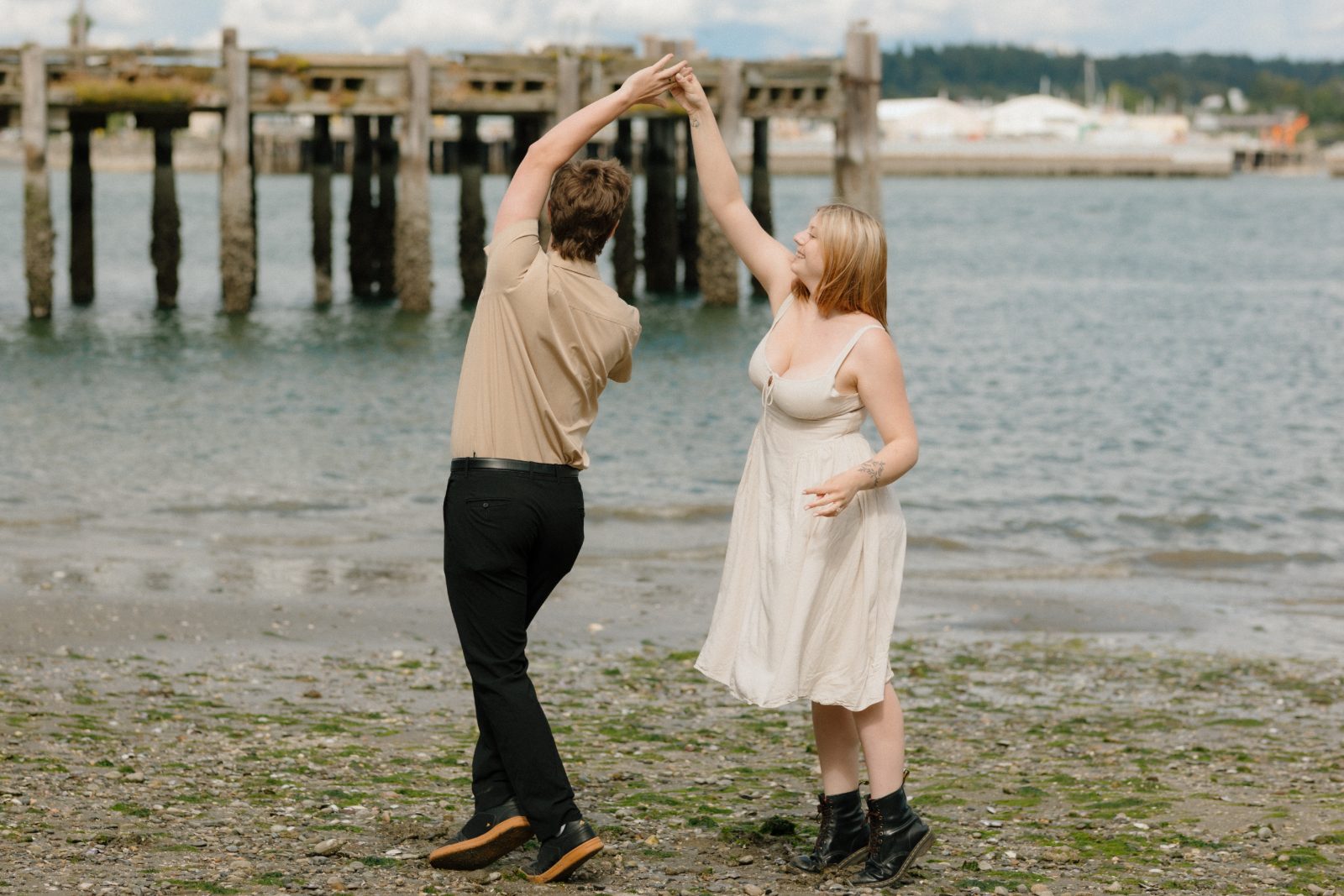 Claire and Evan dancing together on the beach
