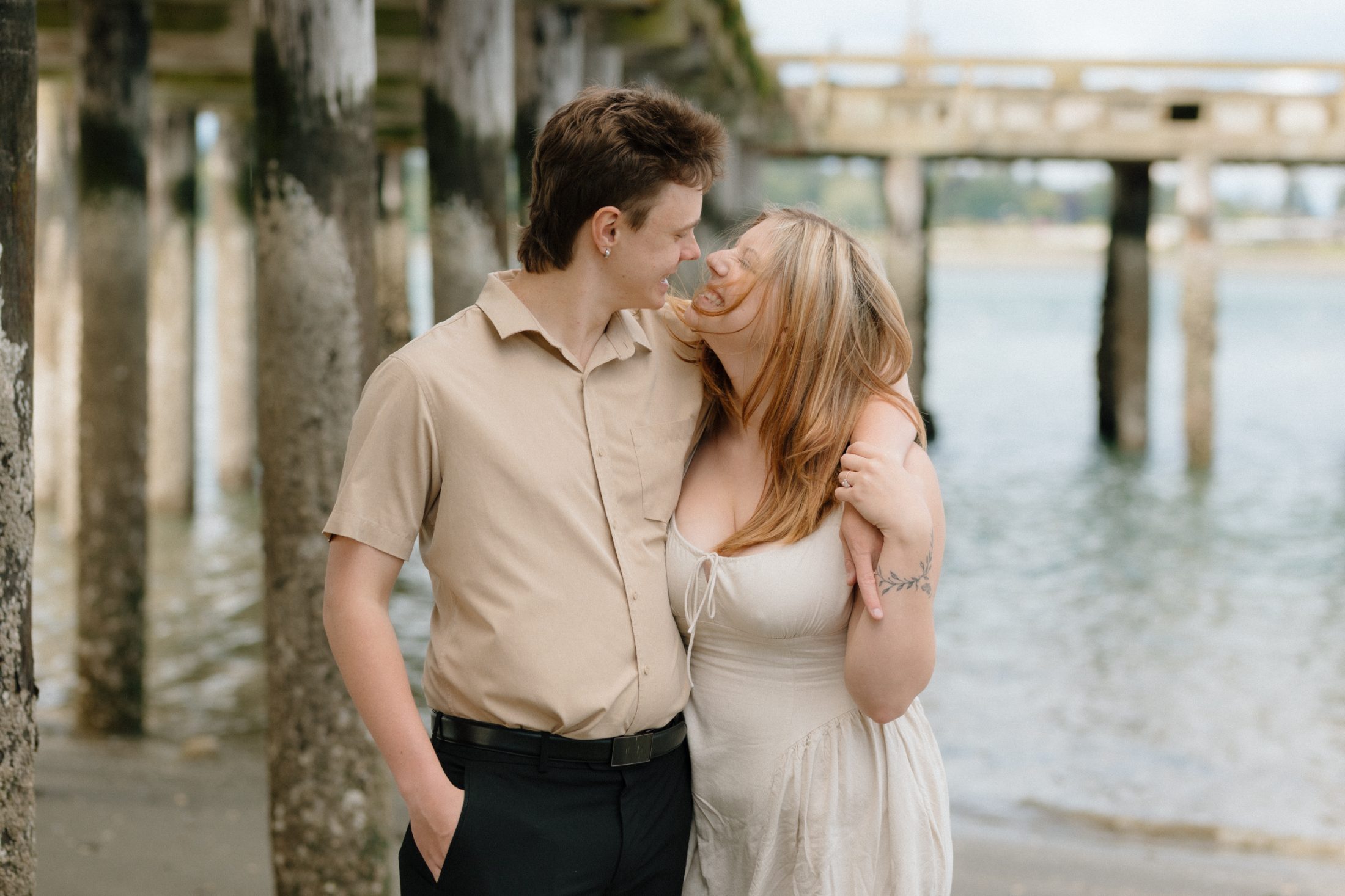 Claire and Evan laughing together by the water