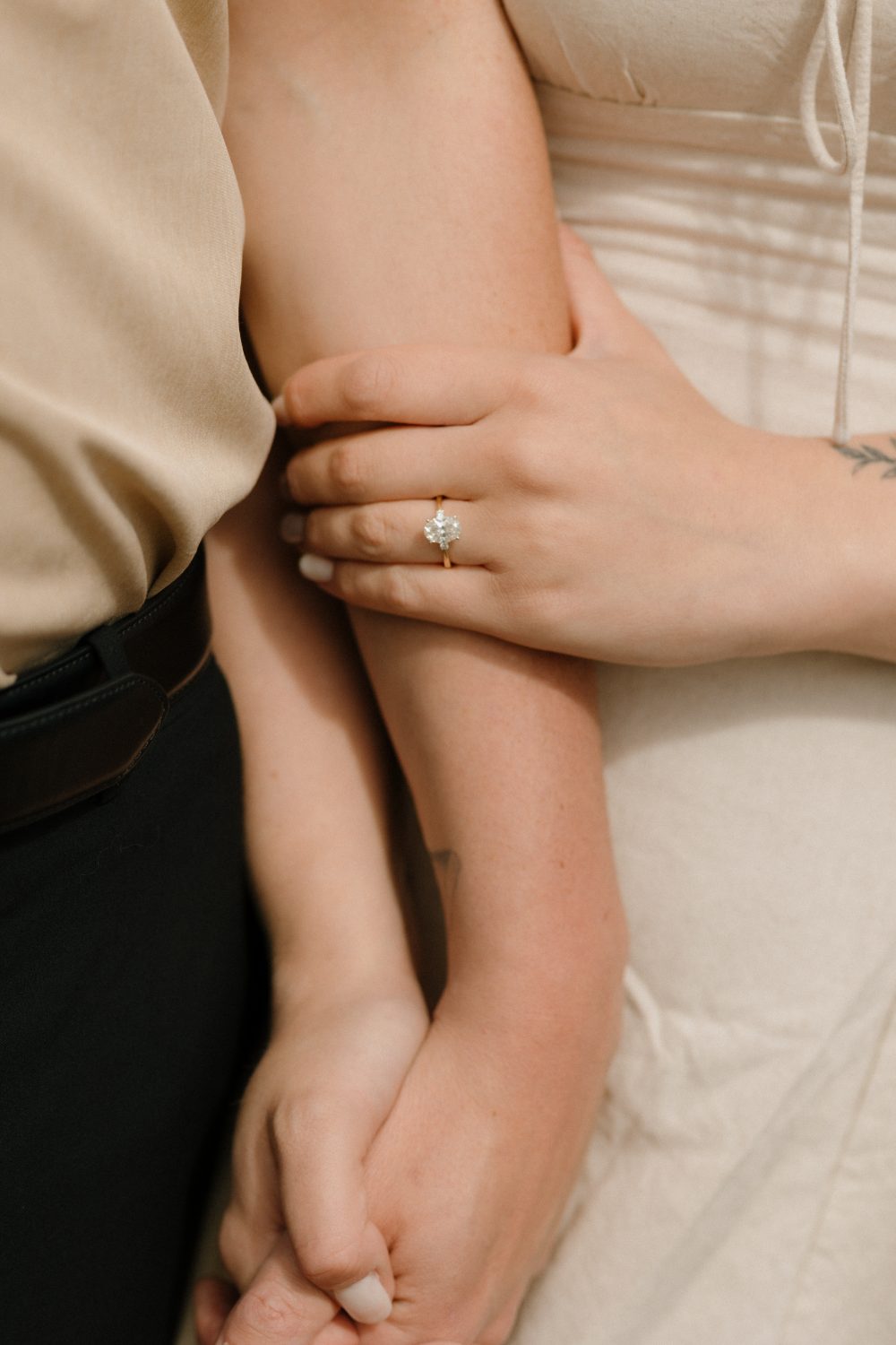 Claire and Evan, hands and engagement ring